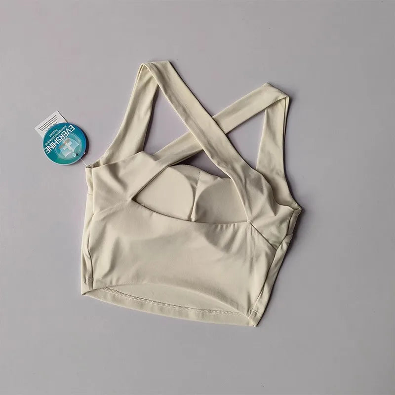 Cream beauty back yoga bra with crisscross straps for comfort and support during workouts