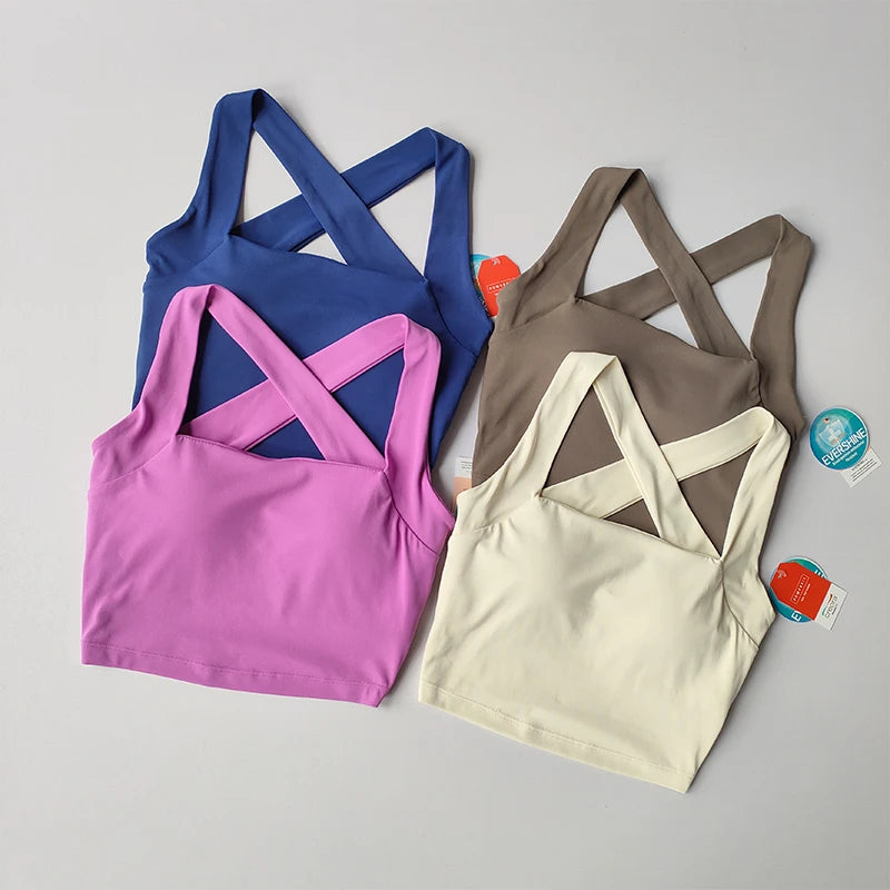 Four stylish beauty back yoga bras in pink, blue, brown and cream for comfort and support