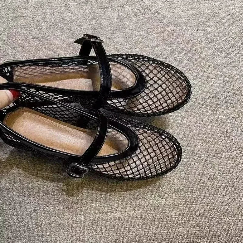 Black mesh fashion sandals with ankle straps from The Lady's Haven Boutique on gray carpet background