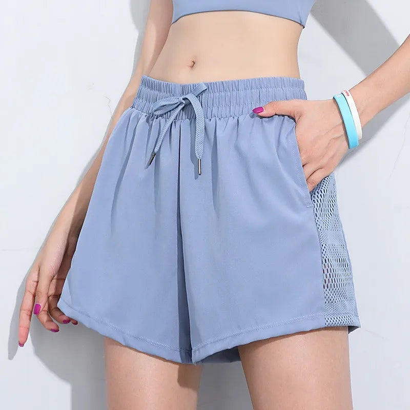 Light blue breathable gym shorts for women with elastic waistband and mesh side panels