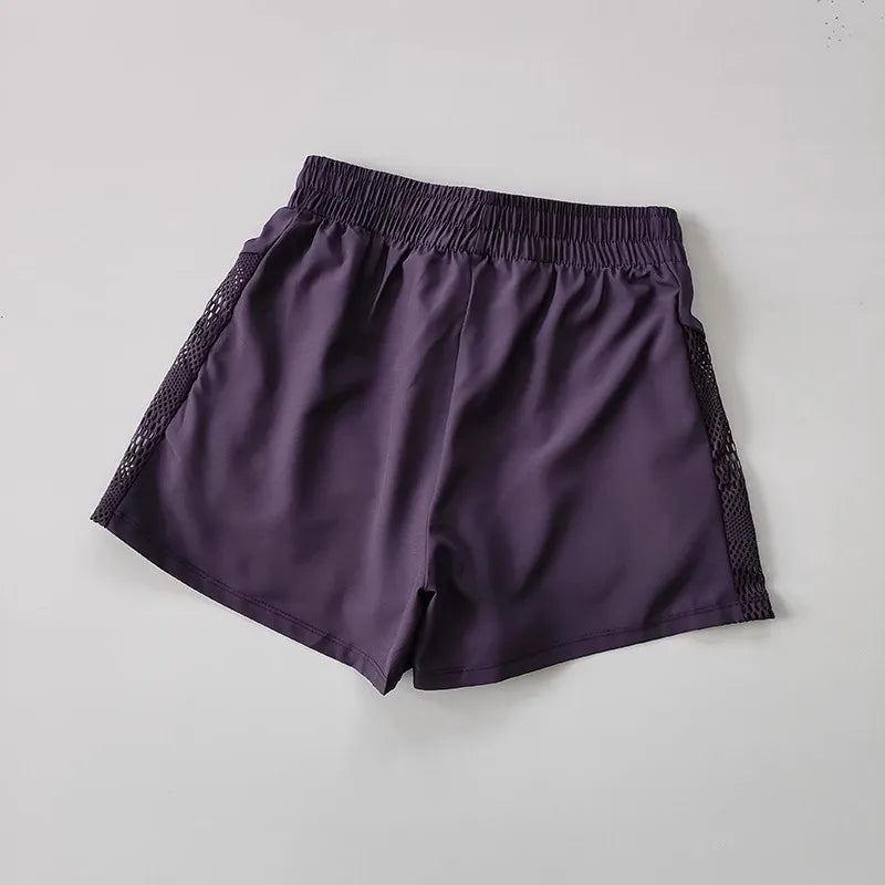 Breathable gym shorts for women in purple with a comfortable waistband and mesh panels