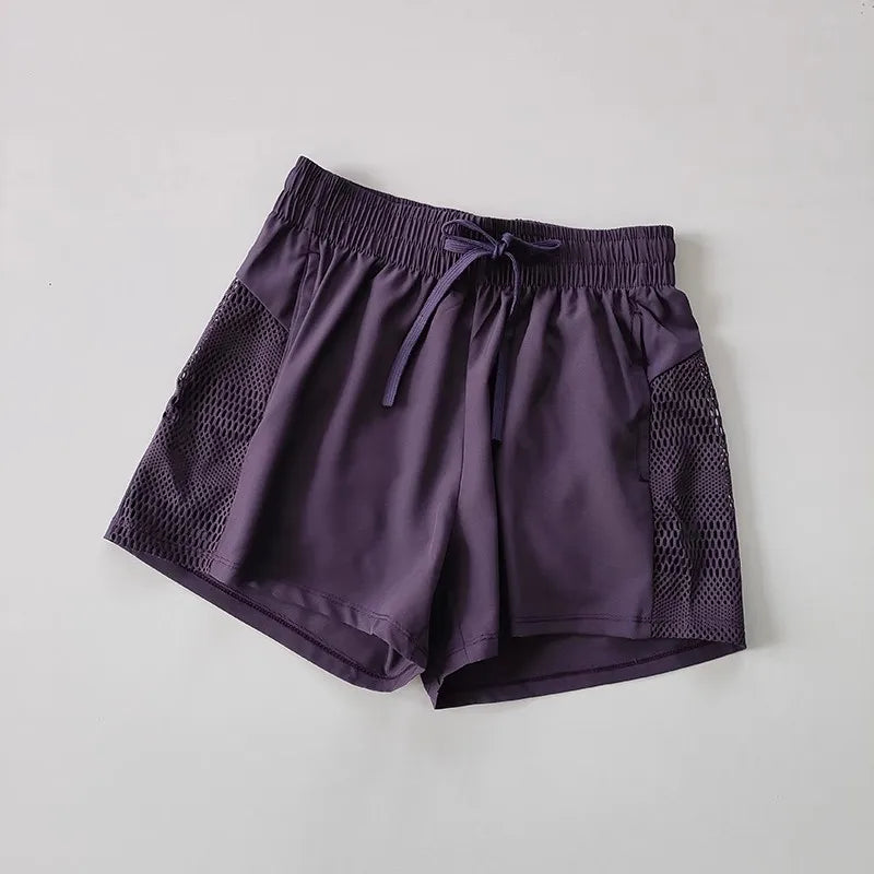 Purple breathable gym shorts for women with mesh pockets and adjustable waistband