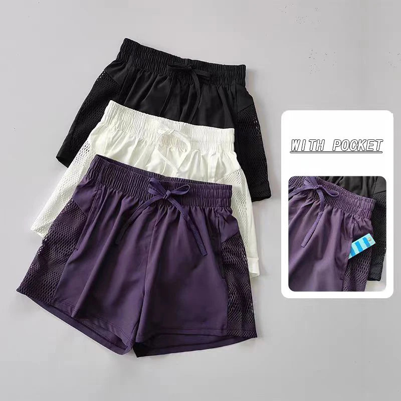 Set of breathable gym shorts for women in black, white, and purple with pockets and breathable mesh design