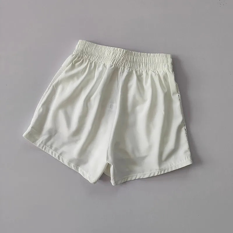 White breathable gym shorts for women with an elastic waistband for comfort and flexibility