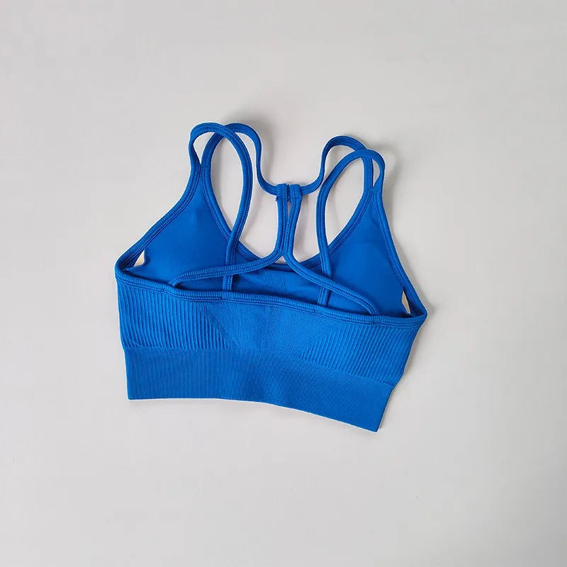 Blue breathable sports bra for women featuring a stylish crisscross back design