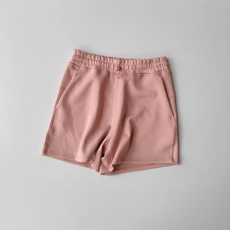 Light pink casual sports shorts for women with an elastic waistband and side pockets
