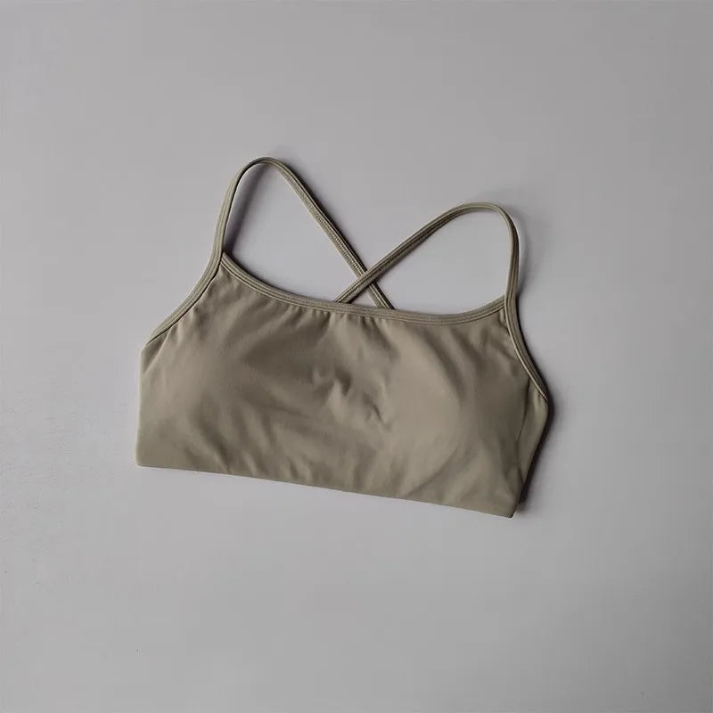Beige cross back sports bra with a smooth, comfortable fit for activewear essentials
