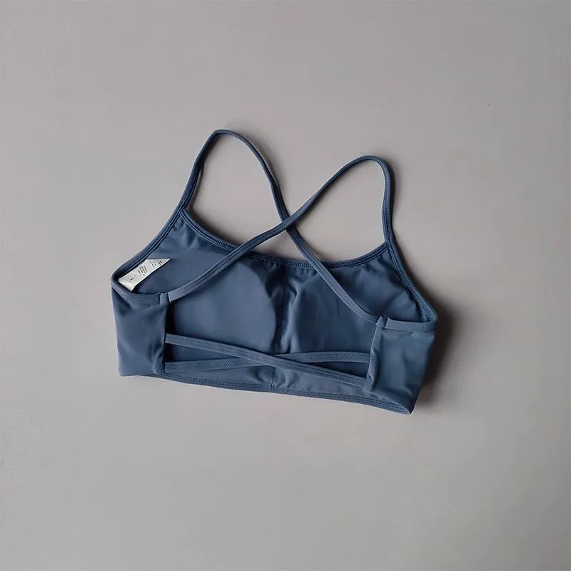 Stylish cross back sports bra in blue, perfect for workouts and active wear