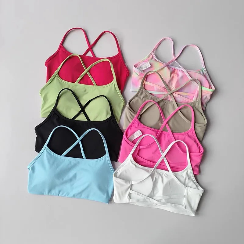 Variety of colorful cross back sports bras in different shades and styles for active wear