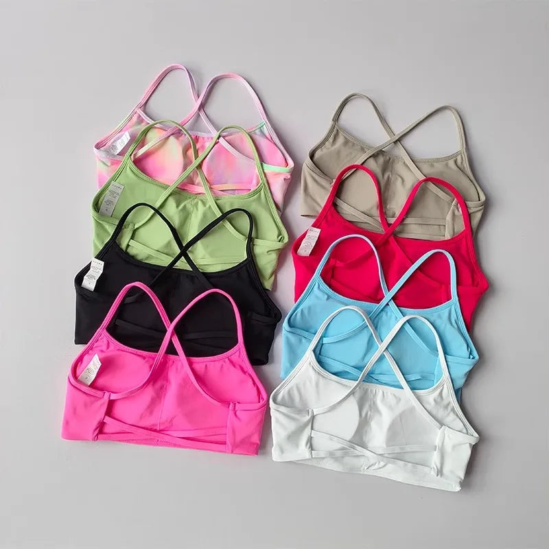 Variety of colorful cross back sports bras from The Lady's Haven Boutique in different sizes