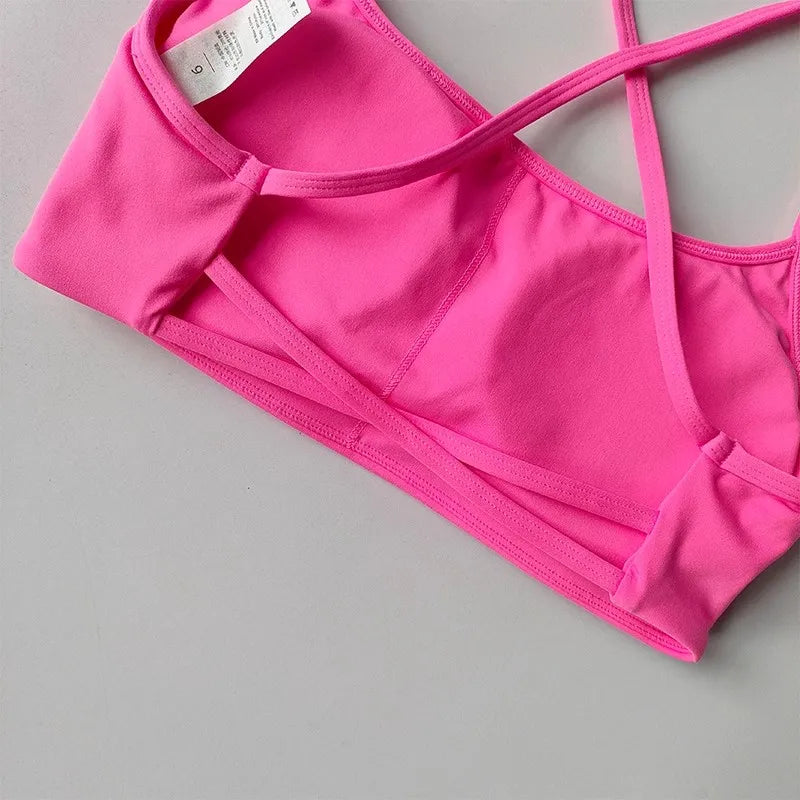 Vibrant pink cross back sports bra with comfortable fabric and adjustable straps
