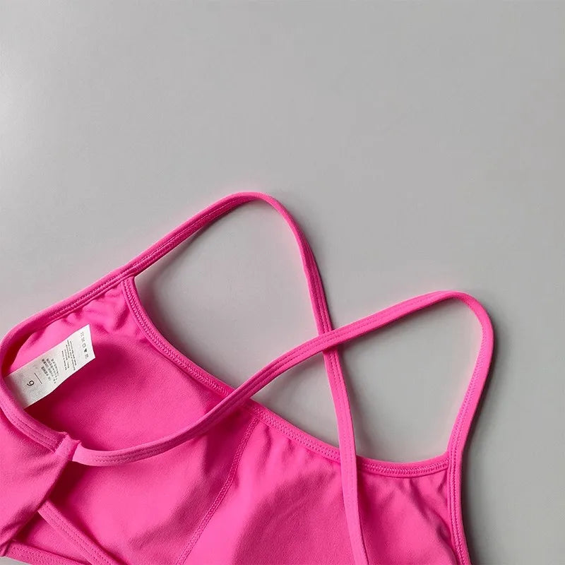 Bright pink cross back sports bra with adjustable straps and soft fabric for comfort during workouts