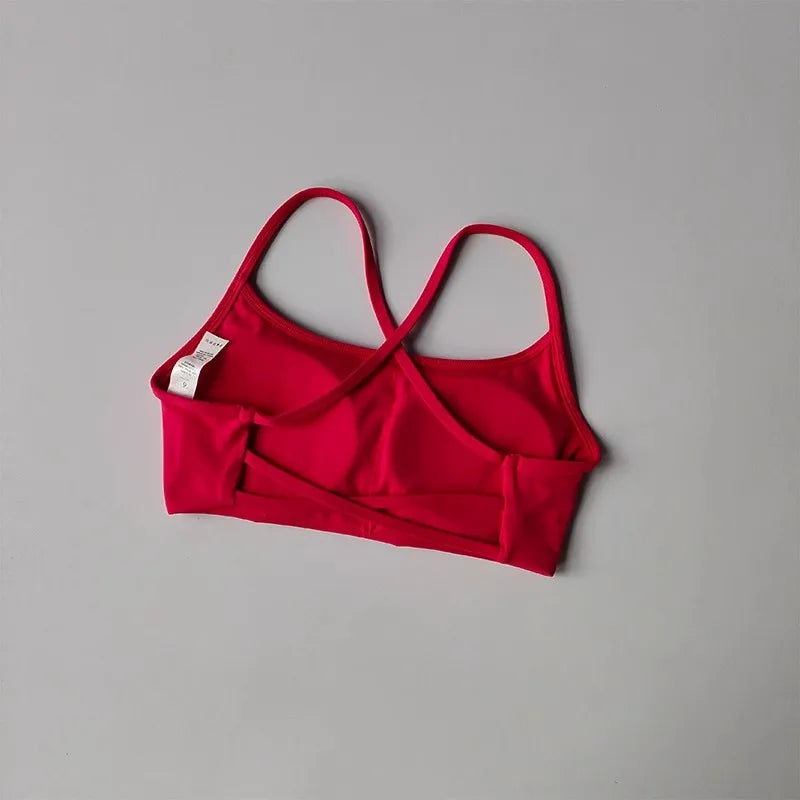 Red cross back sports bra with adjustable straps for comfort and support during workouts