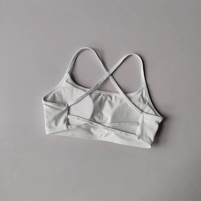 White cross back sports bra with soft fabric and stylish cross-back design for comfort and support