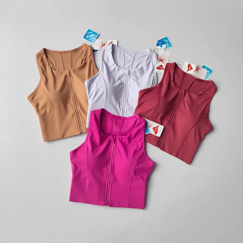Four vibrant colors of front zipper fitness bras displayed together for activewear enthusiasts