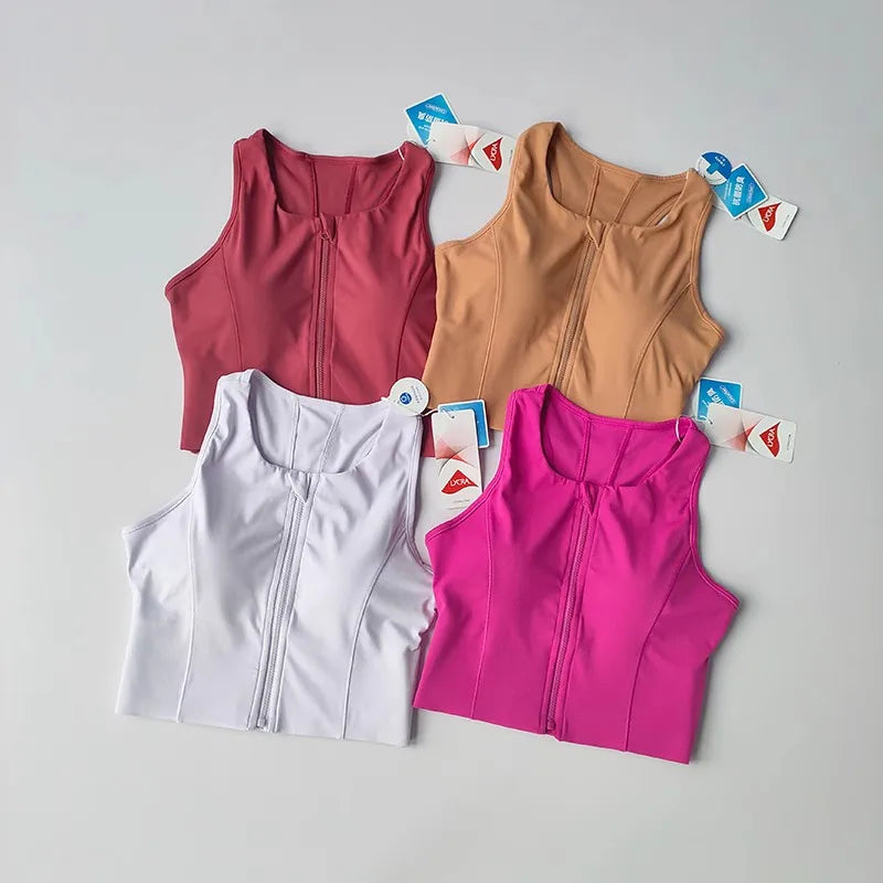 Four colorful front zipper fitness bras in pink, white, nude, and red for stylish workouts