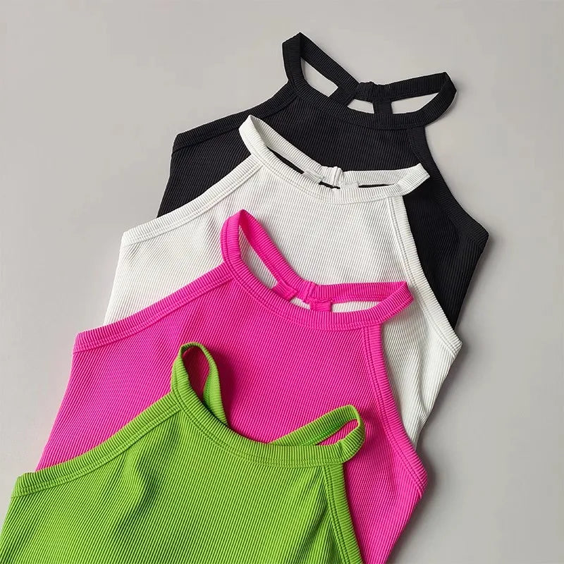Three vibrant gym top fitness camisoles in black, white, pink, and green for stylish workouts