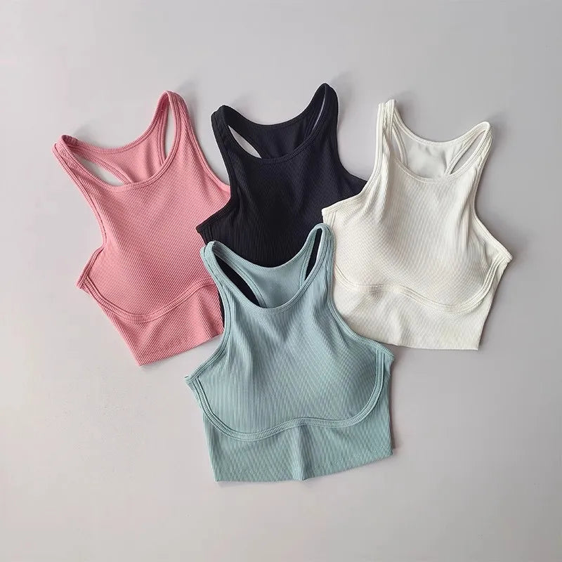 Four high impact sports bras for women in pink, black, white, and light blue colors