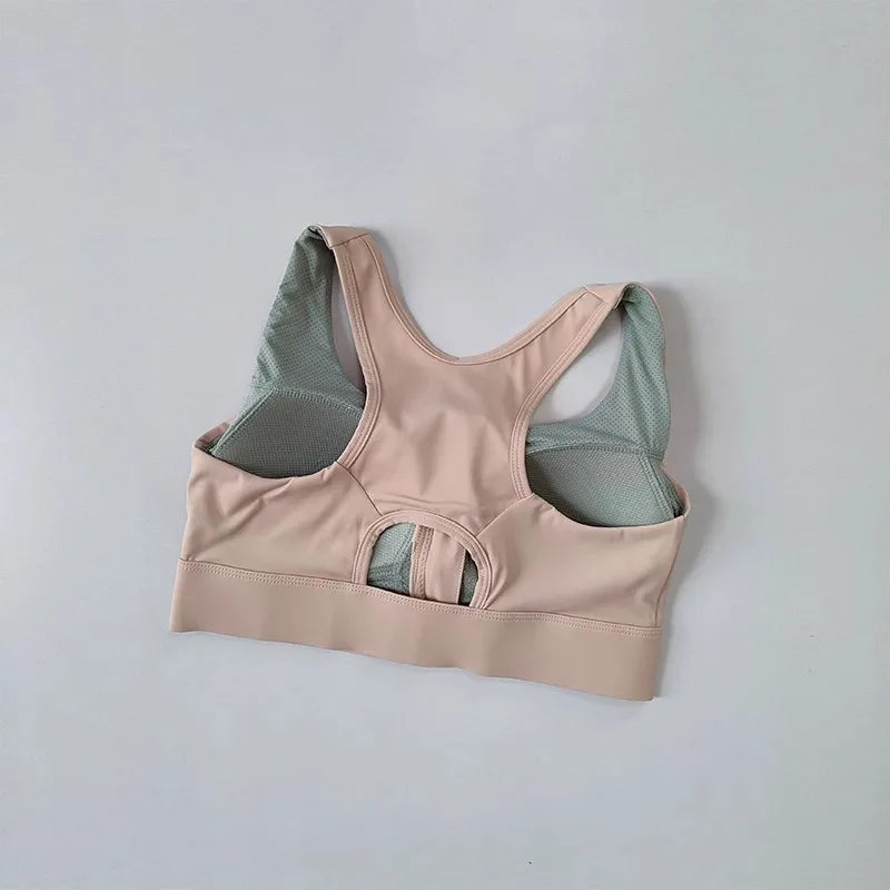 High impact sports bra for women in beige with mesh detailing and a support design