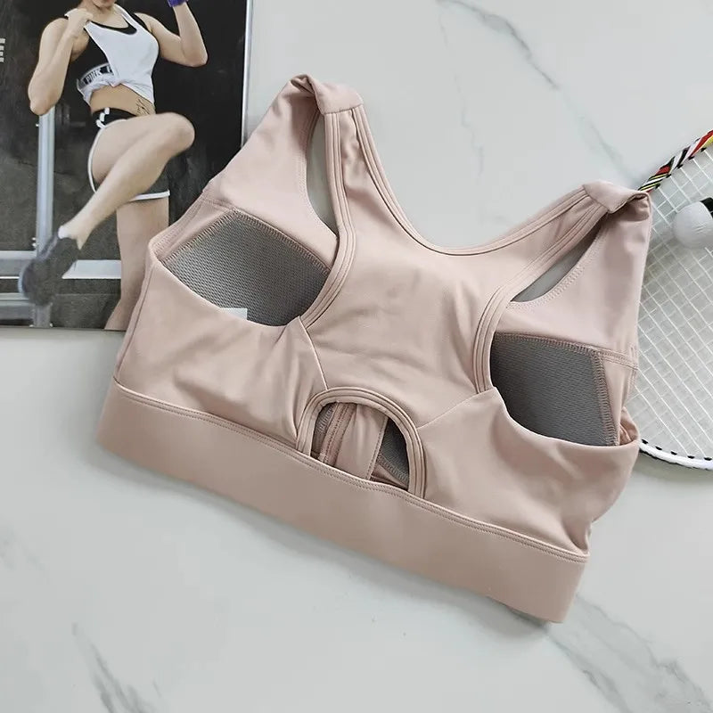 High impact sports bra for women in soft pink with mesh details and racerback design