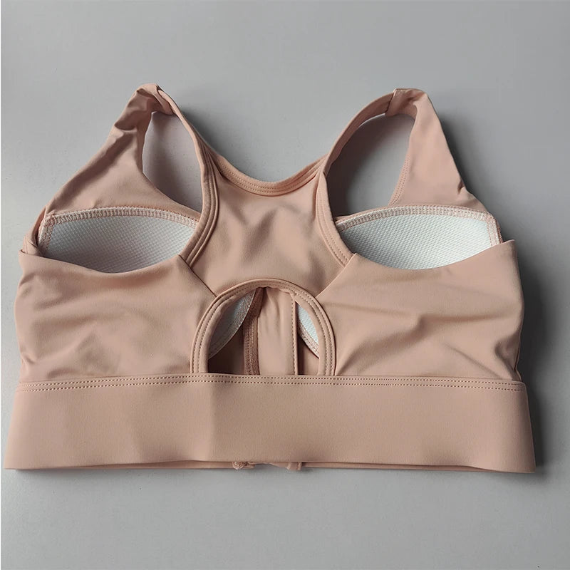 High impact sports bra for women in soft pink with breathable mesh panels for optimal support
