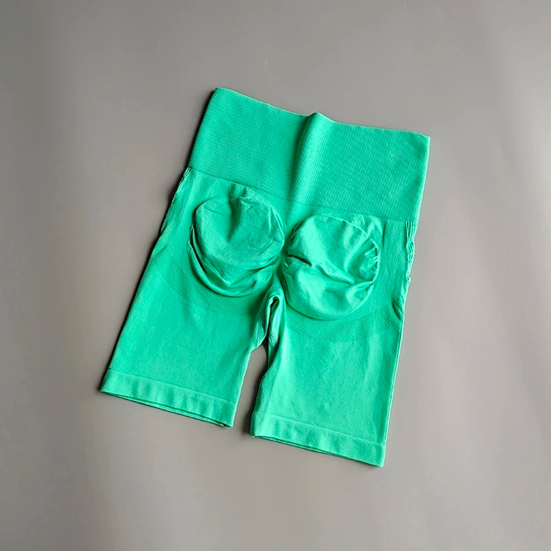 High waist seamless yoga shorts in green with a comfortable fit and two back pockets