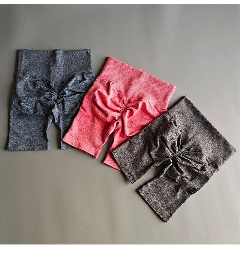 High waist seamless yoga shorts in three colors including pink, blue, and gray for comfortable workouts