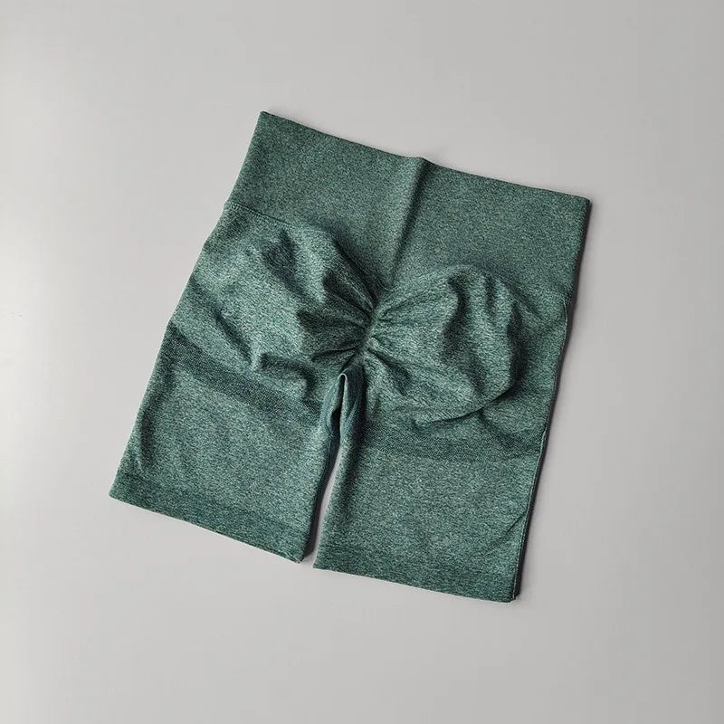 High waist seamless yoga shorts in green fabric with a comfortable design for active wear