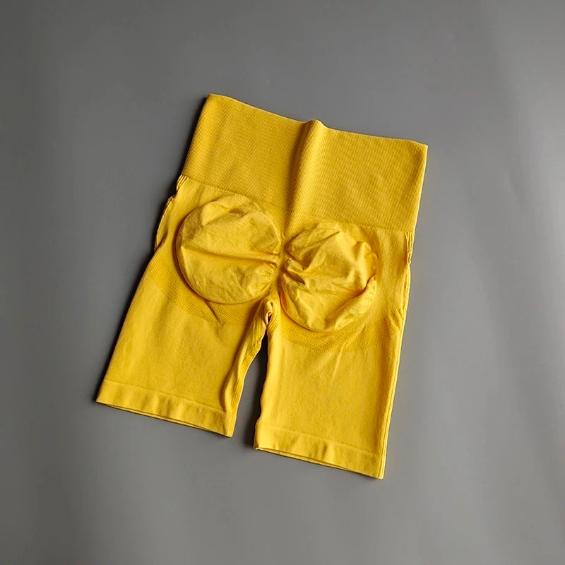 Yellow high waist seamless yoga shorts offering comfort and support for active lifestyles