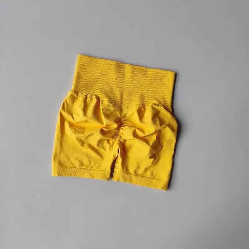 Yellow high-waist yoga shorts women with a ruched back design for comfort and style