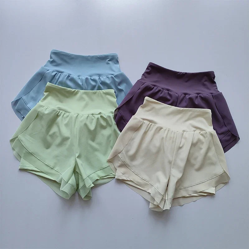 Four pairs of high-waisted sports shorts women in light blue, lavender, yellow, and mint green colors