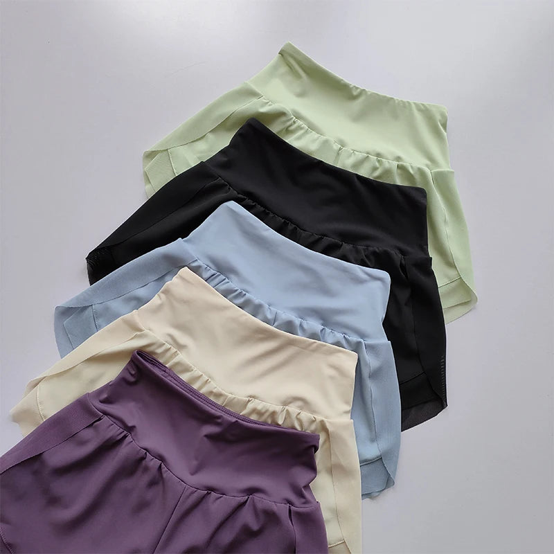 Variety of high-waisted sports shorts women in black, lavender, light blue, mint, and cream colors