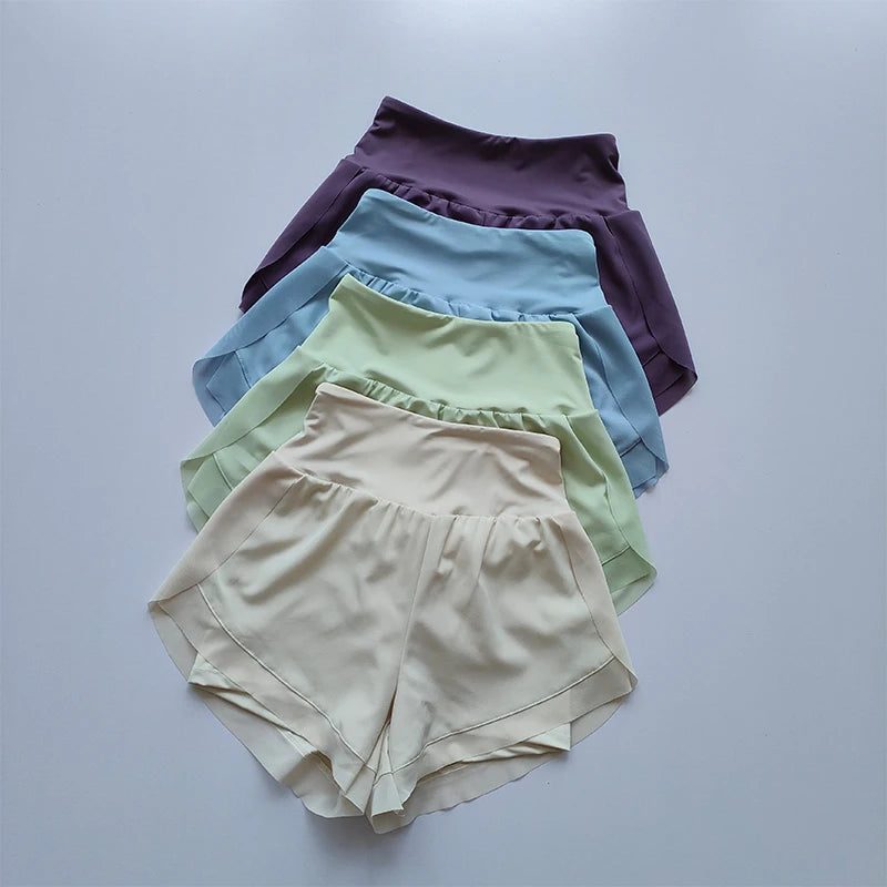 High-waisted sports shorts women in lavender, blue, green, and beige displayed in a row