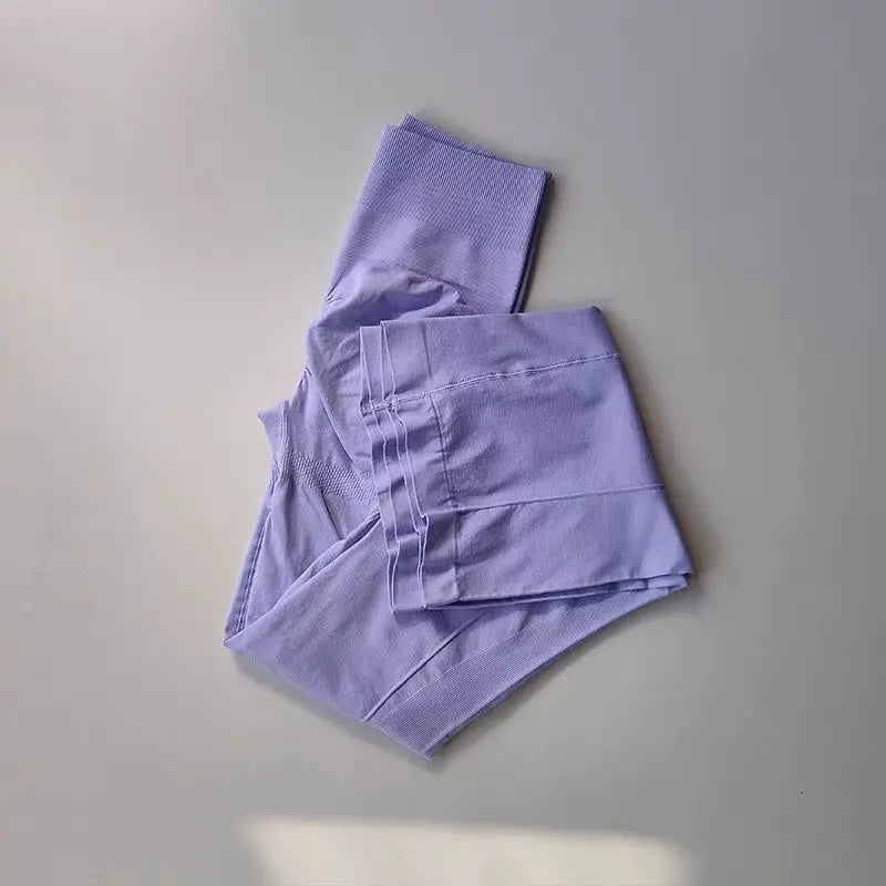 Light purple ladies fitness sweat pants folded neatly for activewear and comfortable workouts