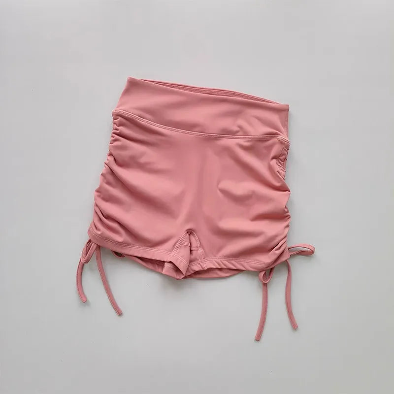 Ladies high waist workout shorts in soft pink with adjustable side ties for comfort and style