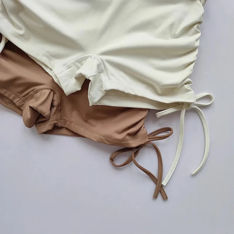 Ladies high waist workout shorts in beige and cream with stylish side ties for comfort and flexibility