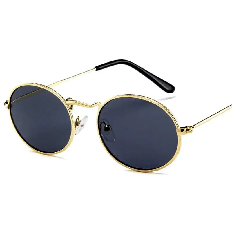 Luxury oval sunglasses women in gold frame with dark lenses for a chic summer look