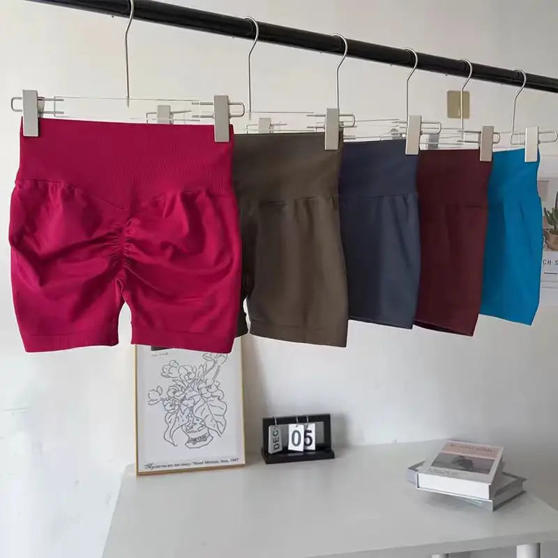 Variety of push-up gym shorts for women in multiple colors hanging on a rack for stylish workouts