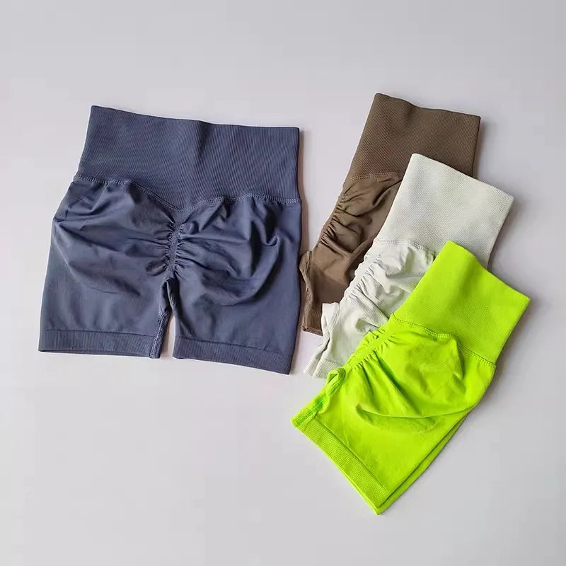 Four pairs of push-up gym shorts for women in various colors with stylish ruching design