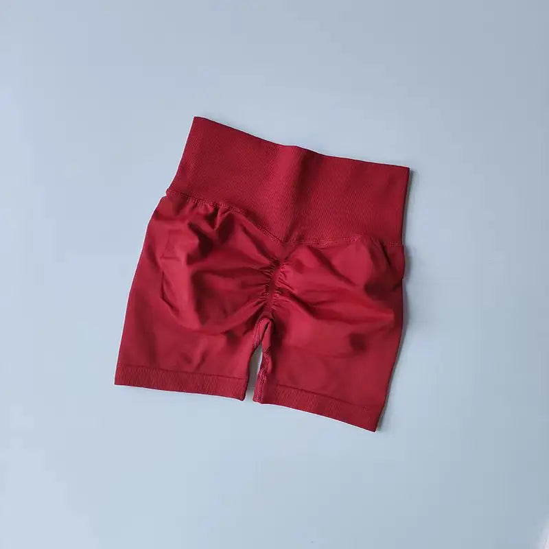 Red push-up gym shorts for women with a high waist and ruching detail for style and comfort