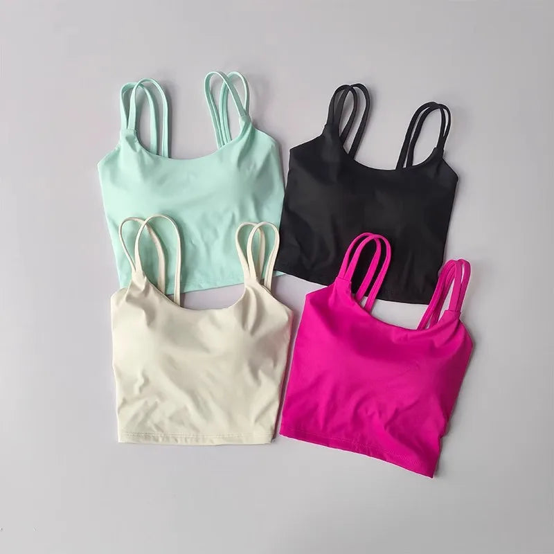 Set of four push up sports bras for women in mint green, black, cream, and pink colors
