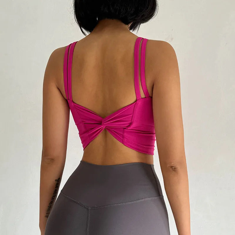 Stylish pink push up sports bras for women featuring a unique back design and adjustable straps