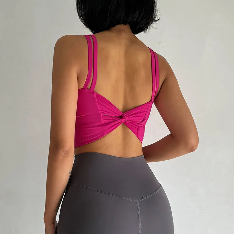 Back view of a pink push up sports bra for women with stylish strappy design, perfect for workouts