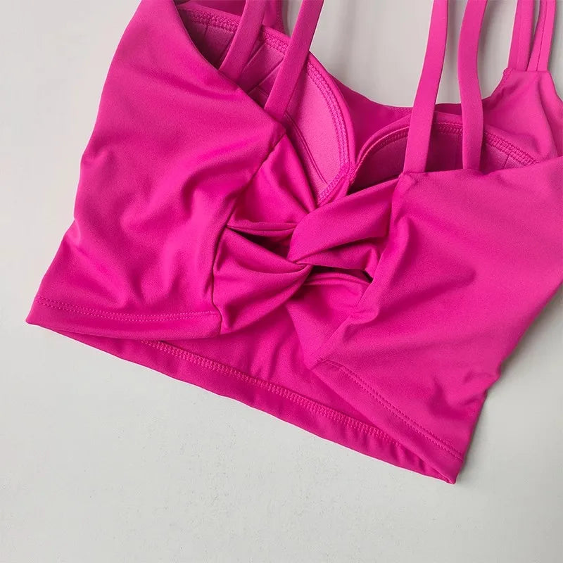 Bright pink push up sports bras for women with a stylish knotted front design