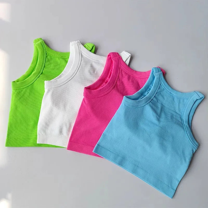Colorful seamless sports vest for women in green, white, pink, and blue, perfect for workouts