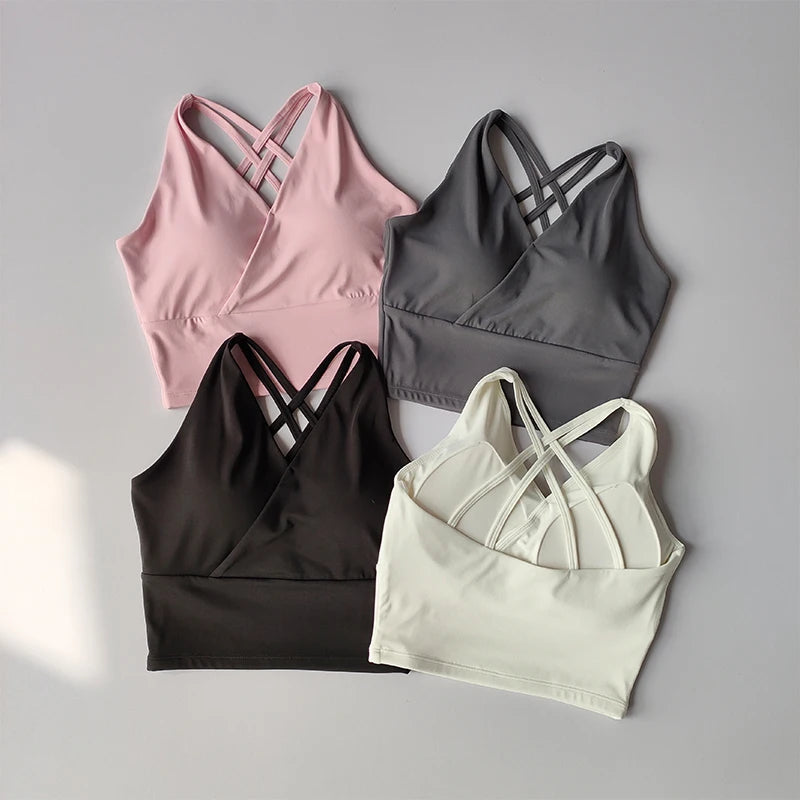 Shockproof crop top for women available in pink, grey, black, and white with stylish cross-back design