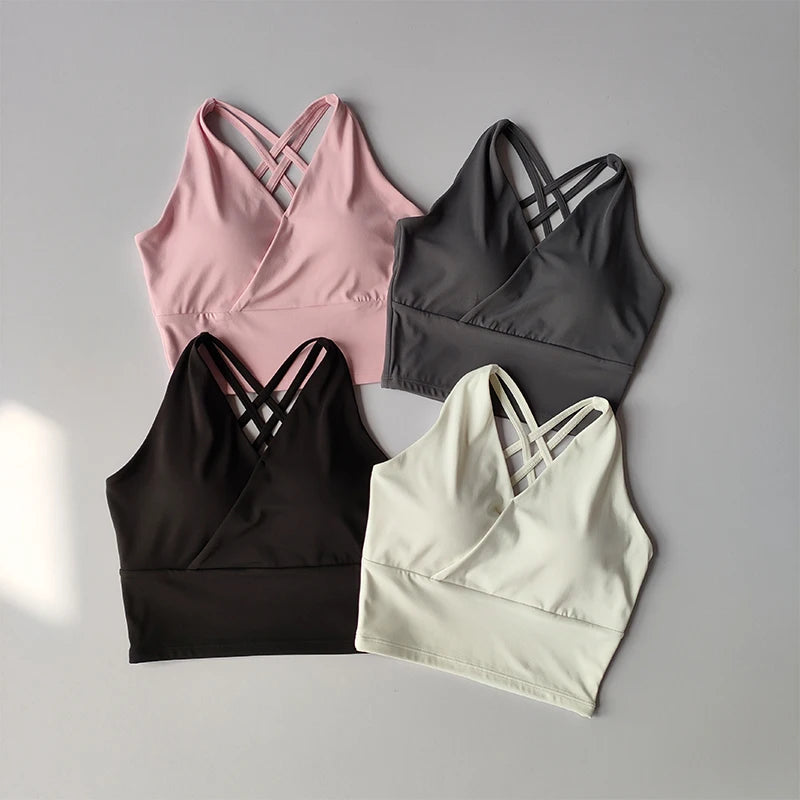 Assorted shockproof crop top for women in pink, gray, black, and white with stylish cross-back design