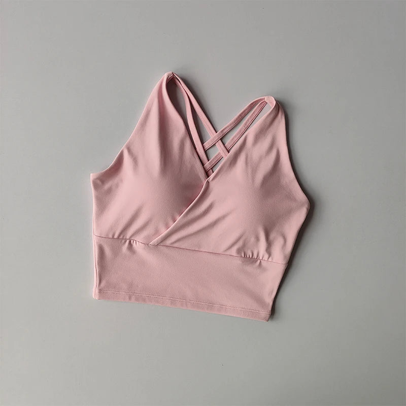Pink shockproof crop top for women with crisscross straps and a comfortable fit