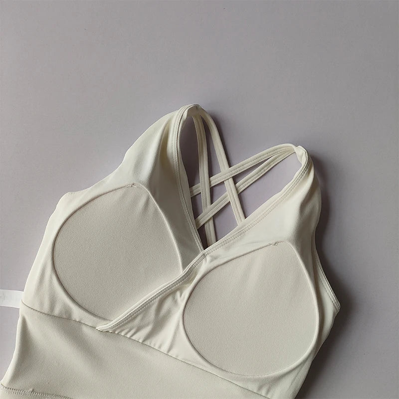 Stylish white shockproof crop top for women with crisscross straps for a trendy look