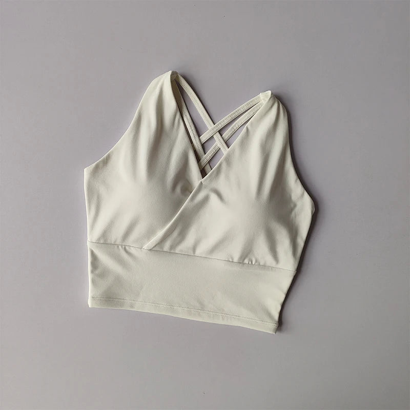 Light beige shockproof crop top for women featuring stylish crisscross straps